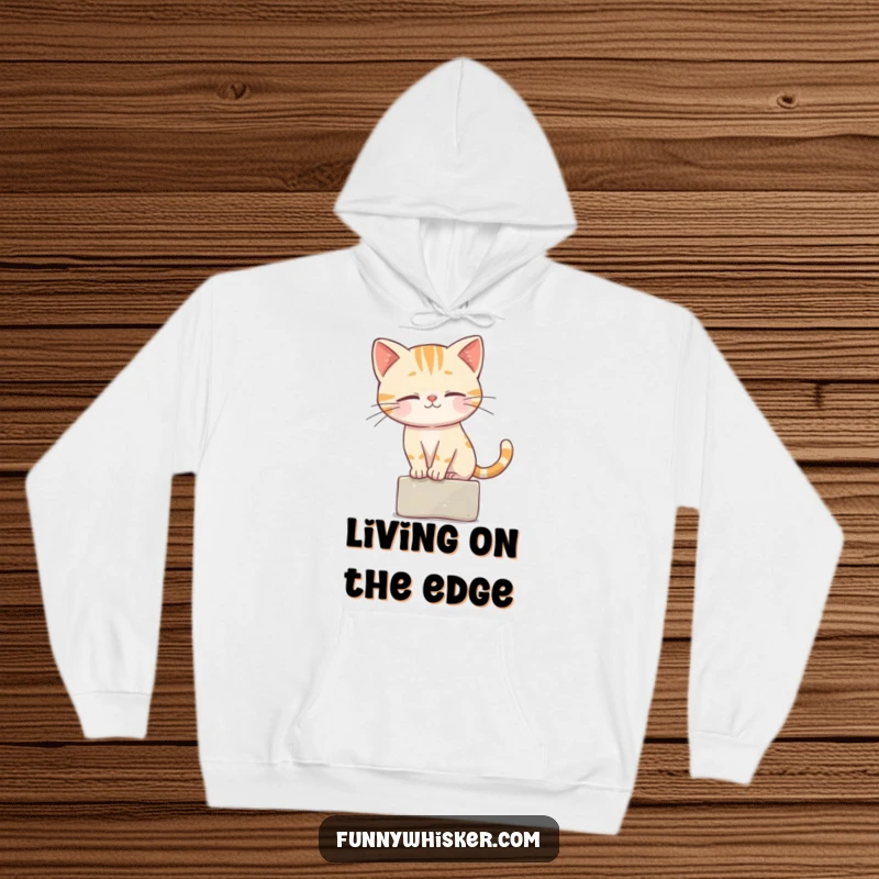 Funny Hoodie showcasing a cat character performing an impressive balancing act on a small ledge with its whiskers.