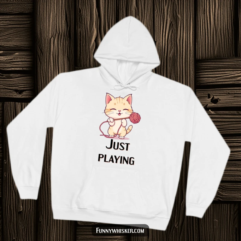 Funny Hoodie: A cat character energetically batting at a floating, fuzzy ball of colorful yarn.