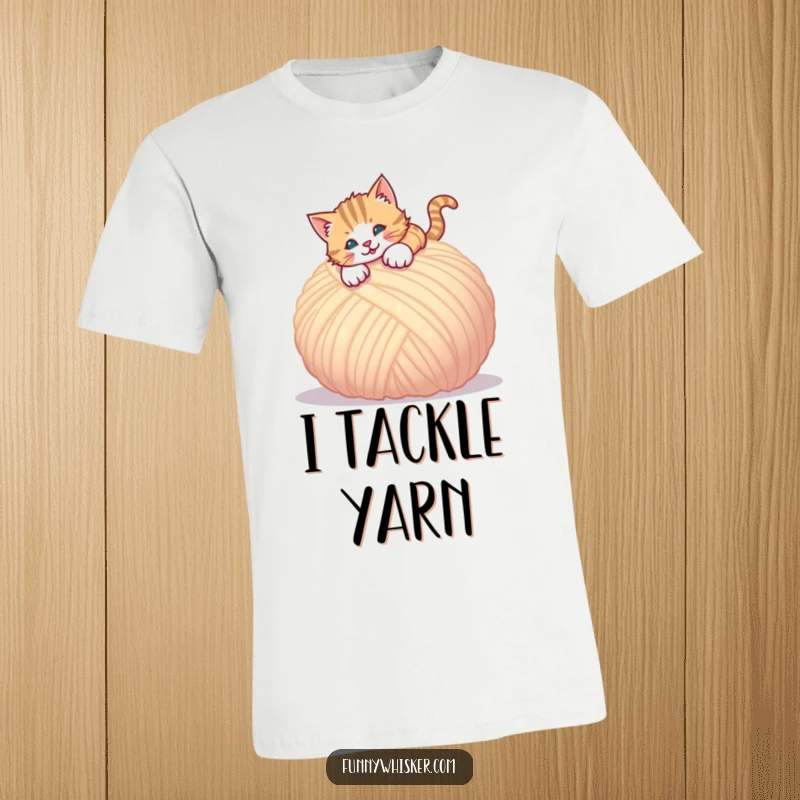 Funny t-shirt depicting a cat in mid-air, playfully pouncing towards a large, soft ball of yarn.