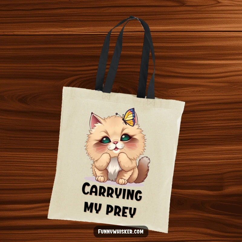 Funny Tote Bag featuring a fluffy cat with oversized whiskers playfully batting at a dancing butterfly illustration.