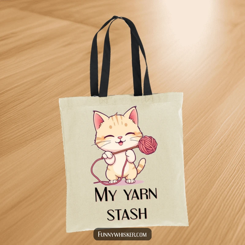 Funny Tote Bag: A cute cat character playfully batting at a dangling, fuzzy ball of yarn.