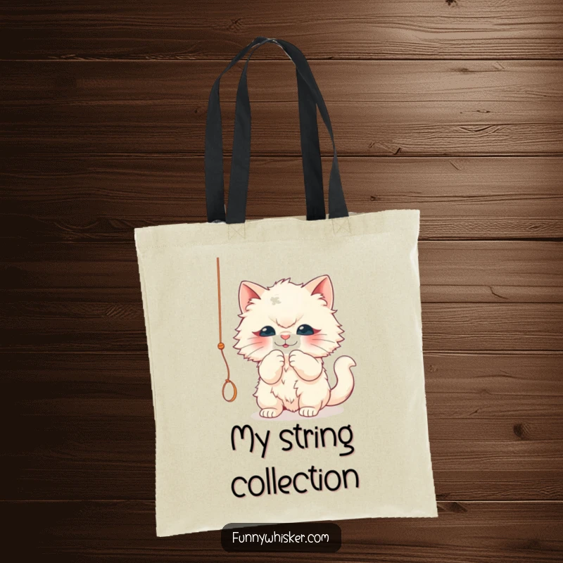Funny tote bag with a fluffy cat character playfully batting a dangling string. Humorous and practical, a great funny gift.